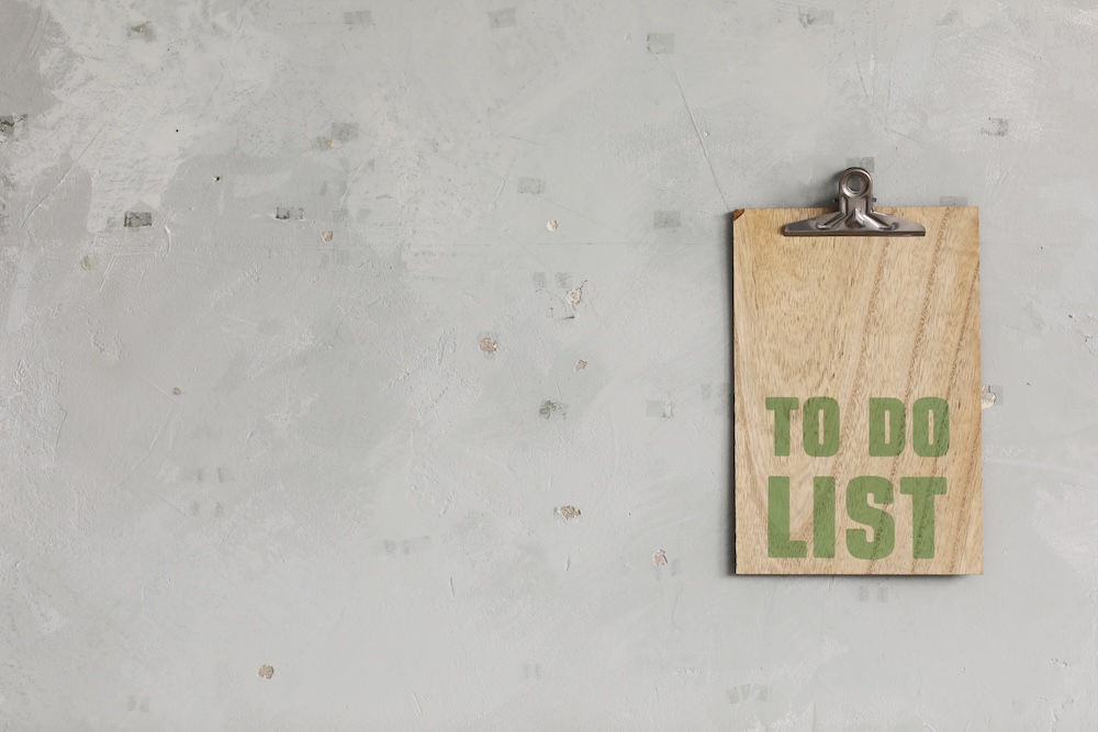 green words spelling to do list on a wooden board