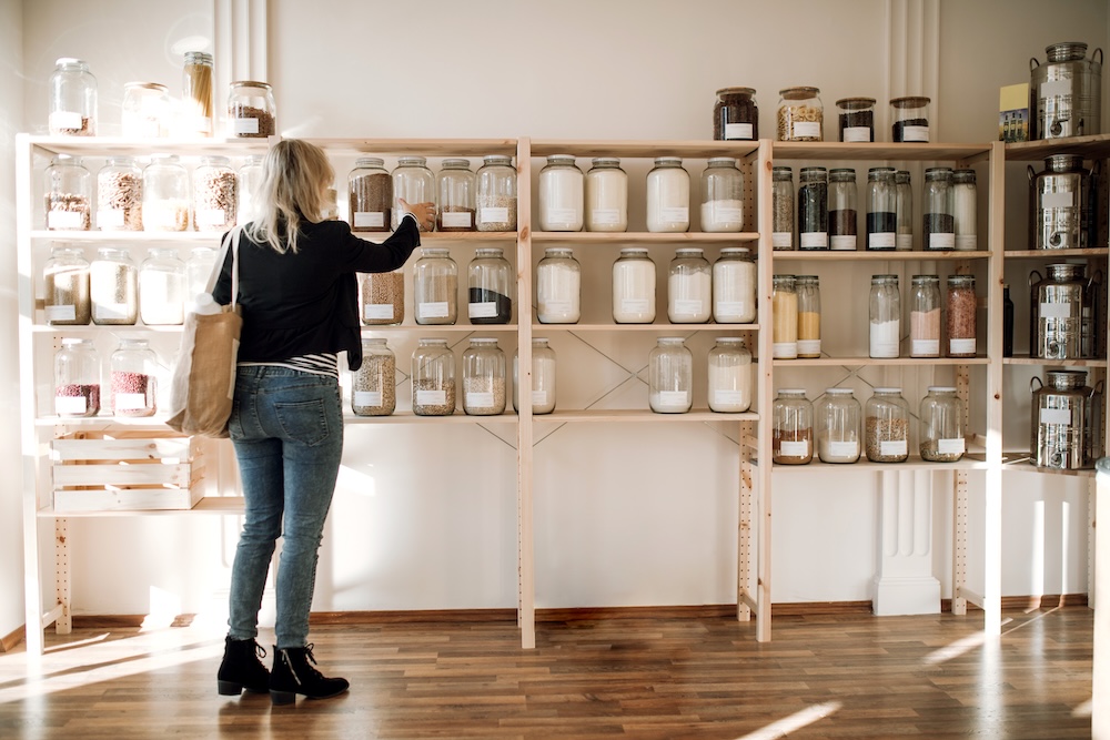 Young woman buying groceries in a zero waste shop