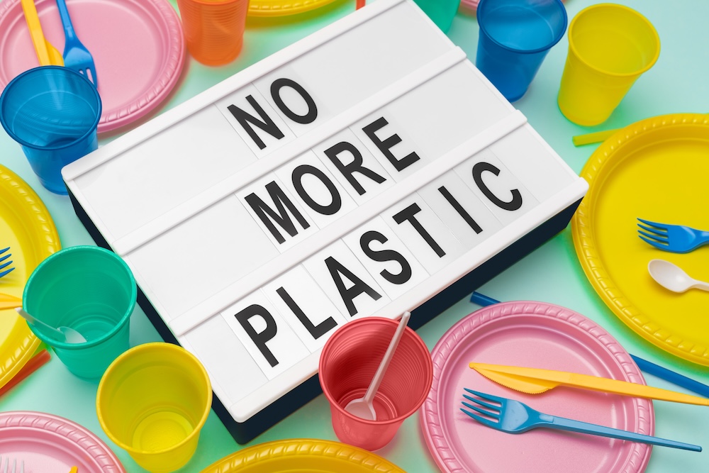 Sign that says no more plastic with single-use plastic around