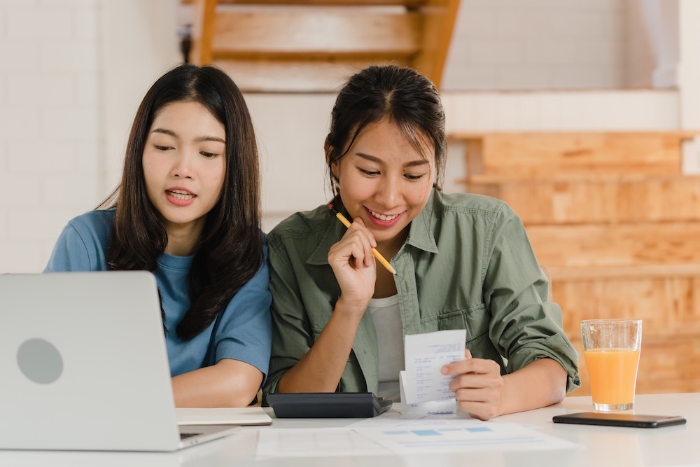 Two young women budgeting their expenses
