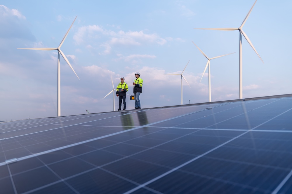engineers walking on solar panel roof
