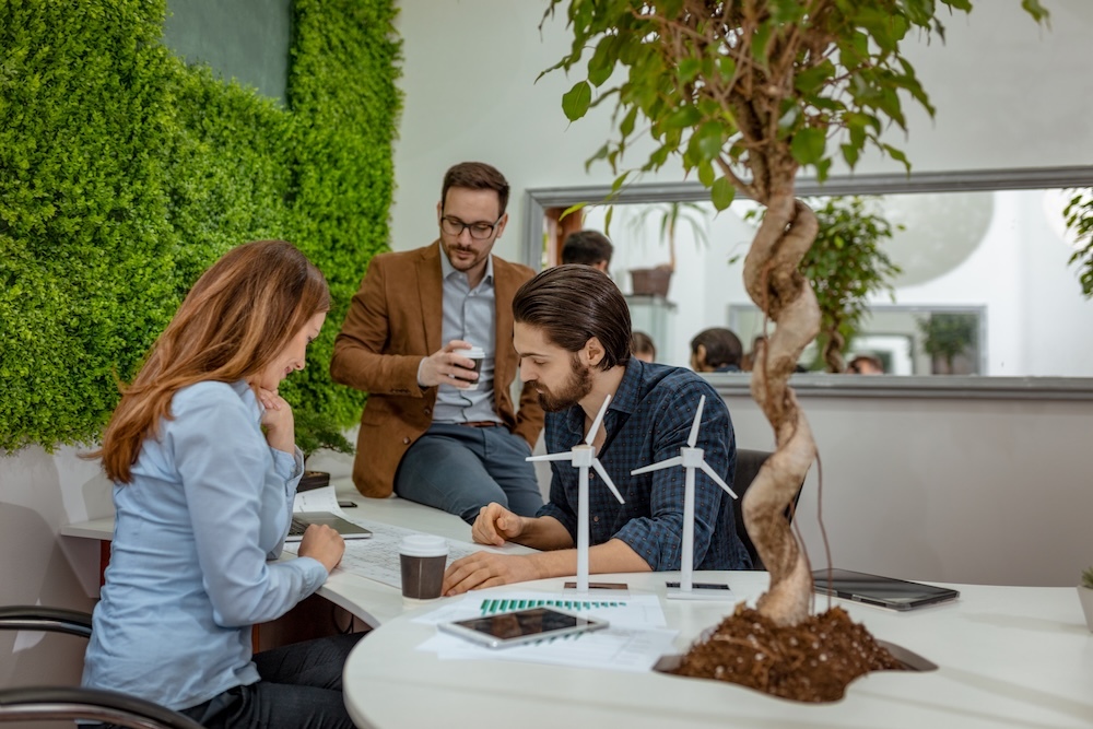 Business people focused on sustainability with wind turbines