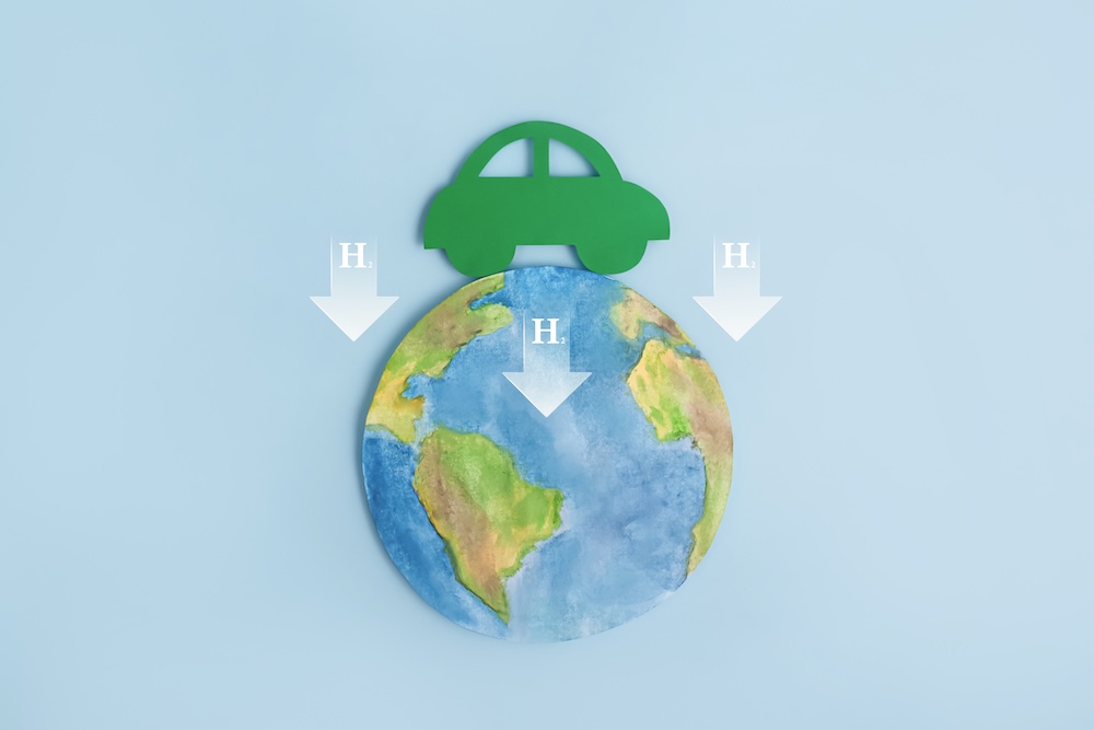 Green car on top of earth with h2 arrow going downward