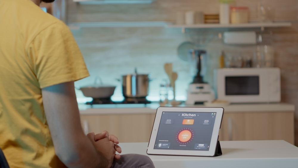 person looking at a smart home app on tablet