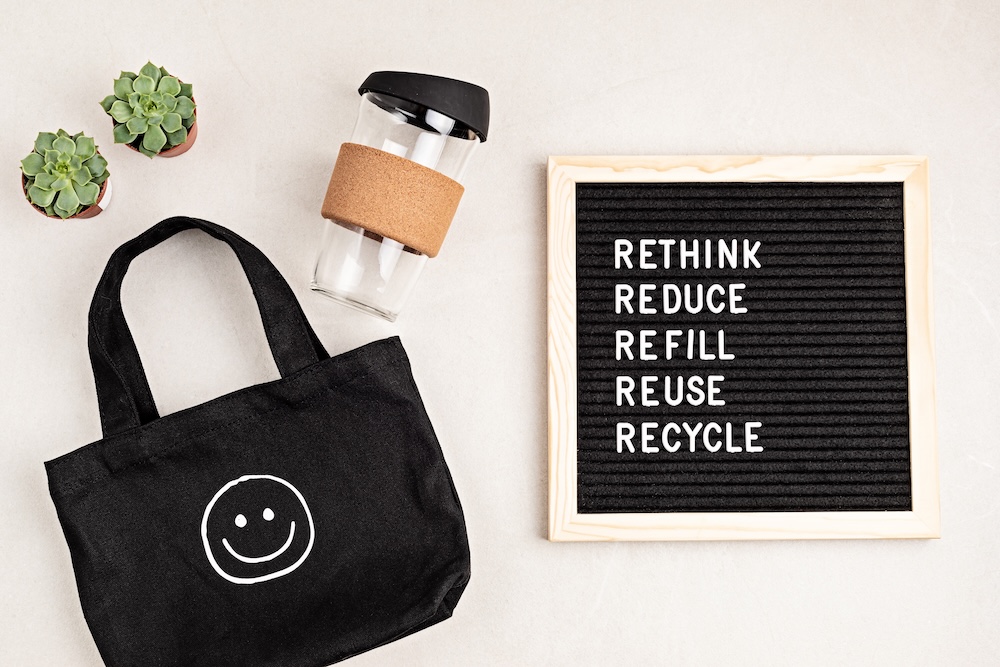 Reusable items with reduce, refill, reuse, recycle on a sign