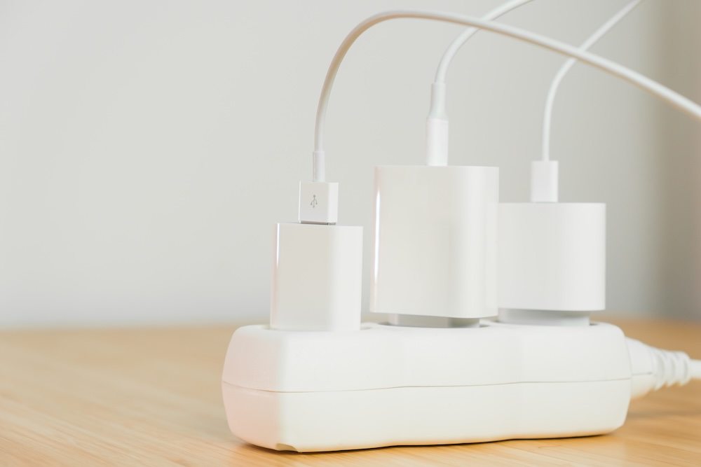Power strip with multiple plugged in chargers for devices
