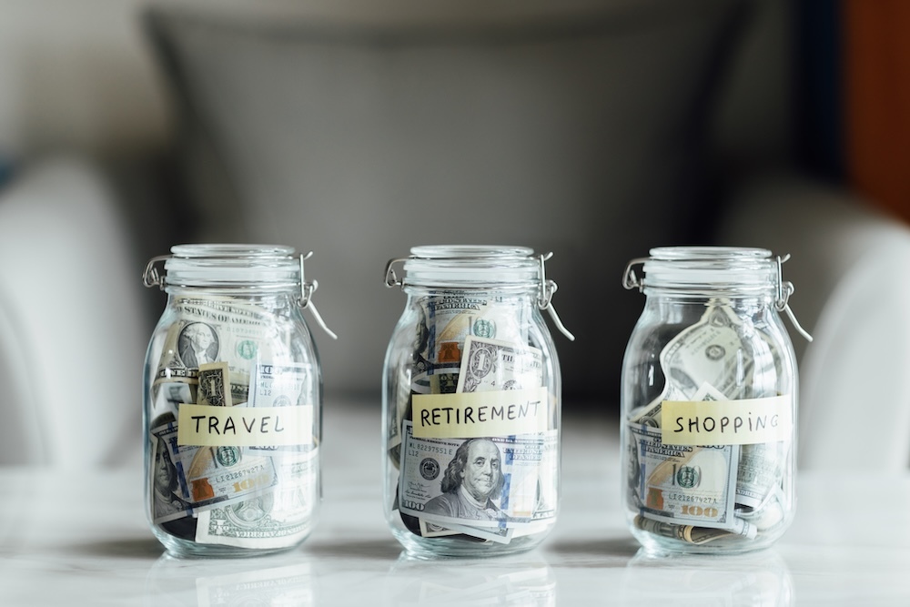 Three glass jars with cash money saved inside