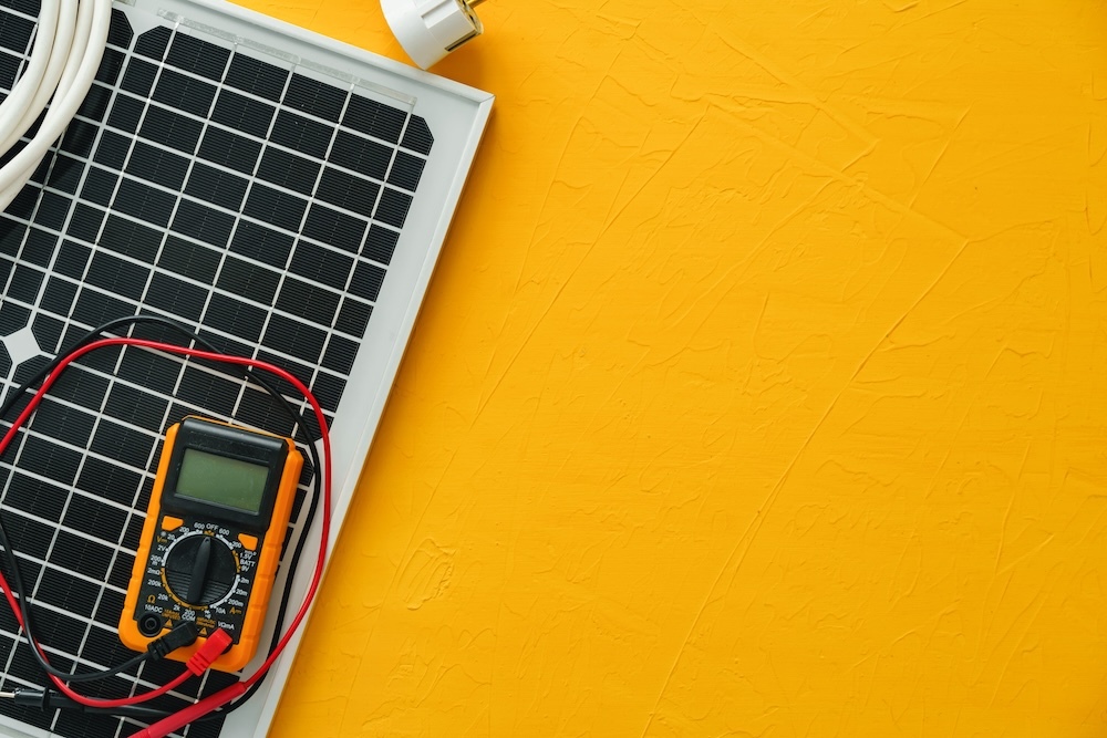 Solar panel with solar energy reader on a yellow background