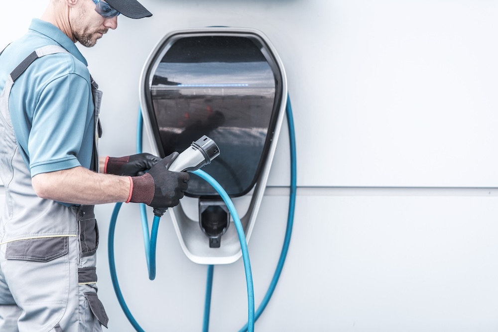 Man holding electric vehicle charger