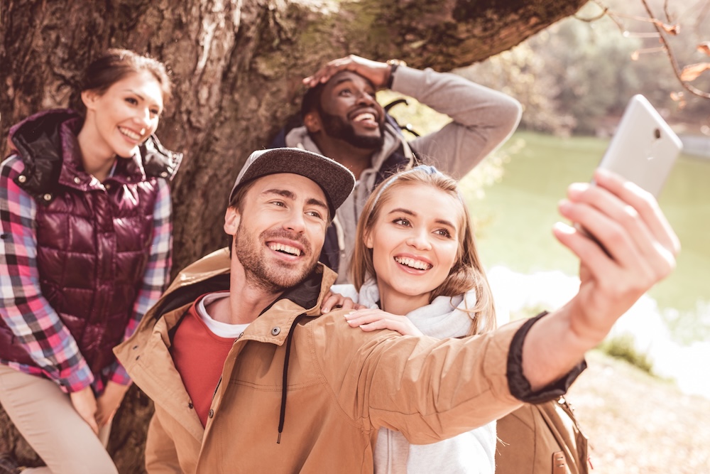 Young group of friends taking a selfie outdoors