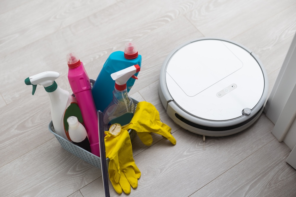 Bucket of household cleaners with robot vacuum