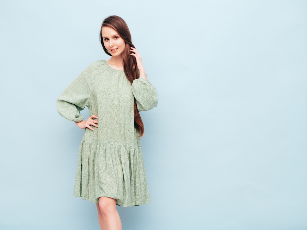 Young woman wearing a light green drop waist dress