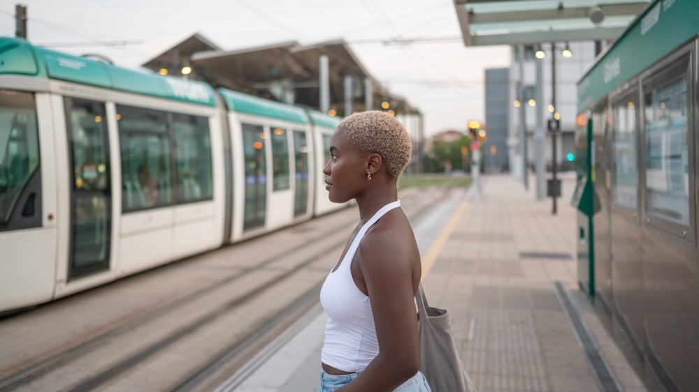 Young woman waiting for tram to come