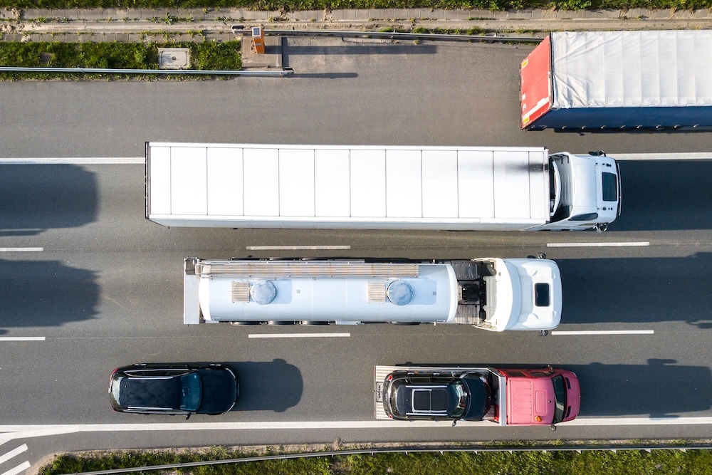 Freight trucks and cars on a highway