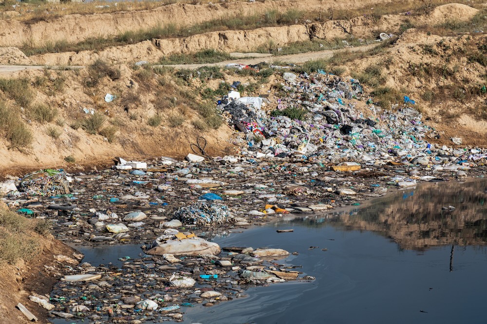 Toxic trash polluting water in a pond