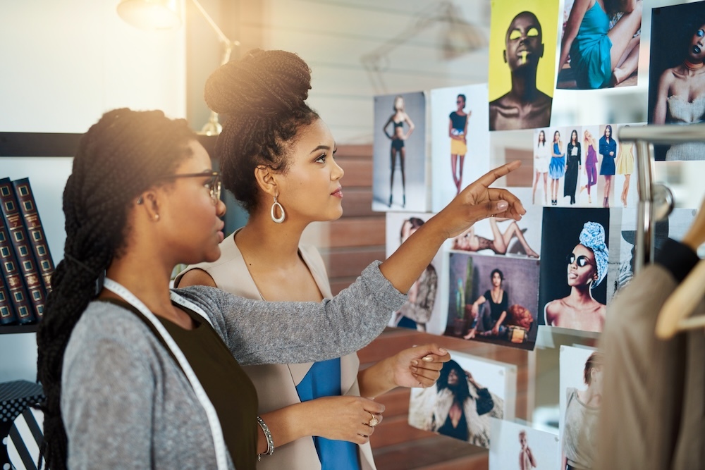 Two female designers collaborating on fashion trends