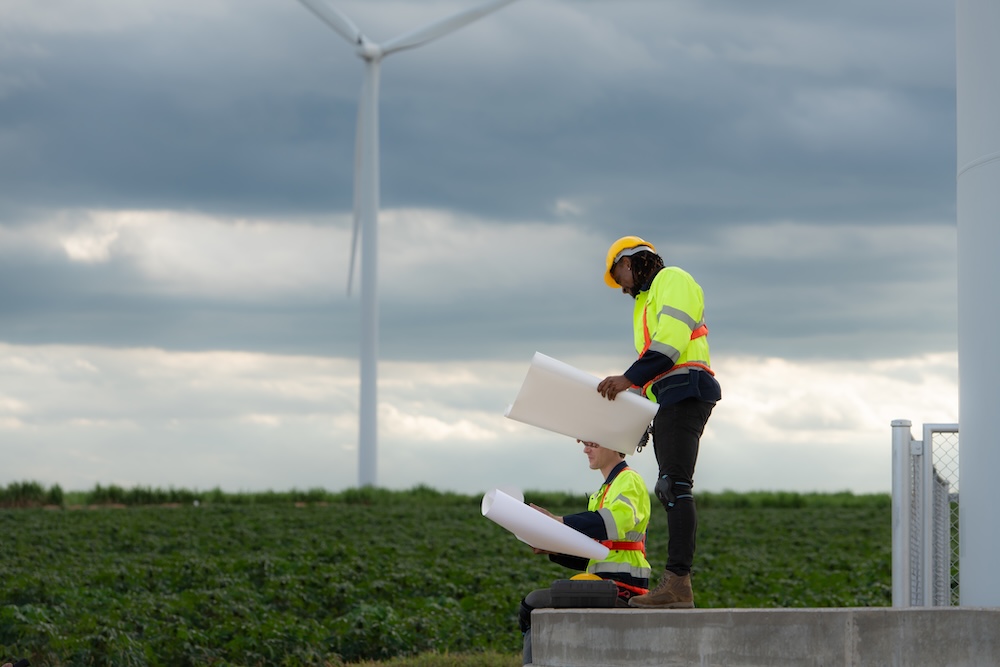 Two engineers working together on wind turbines