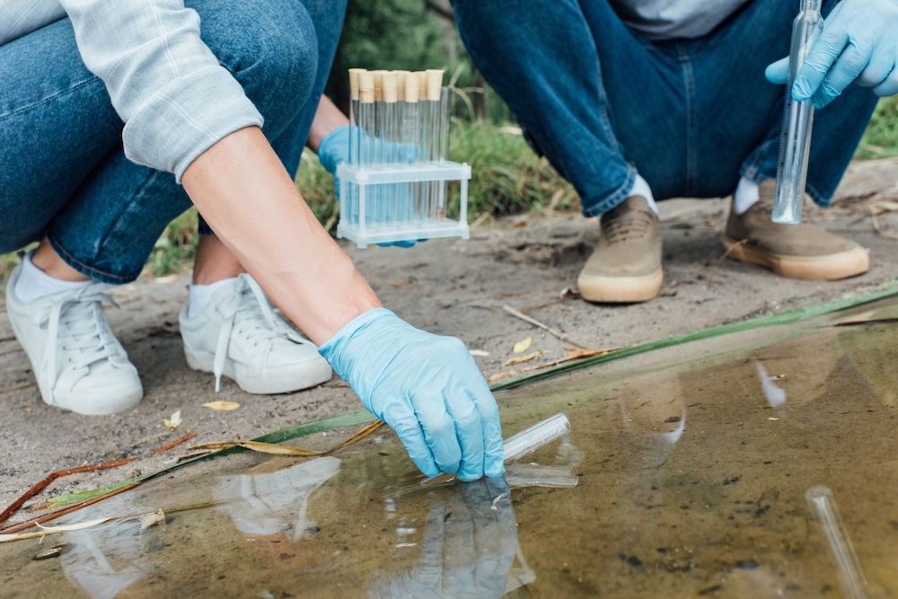 scientist collecting samples of water