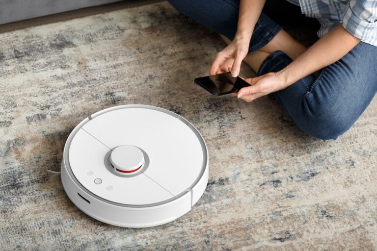 Person configuring a smart vacuum on their smartphone