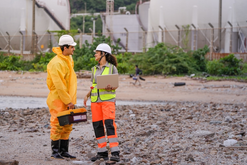 Two environmental research scientist measuring impact from shore