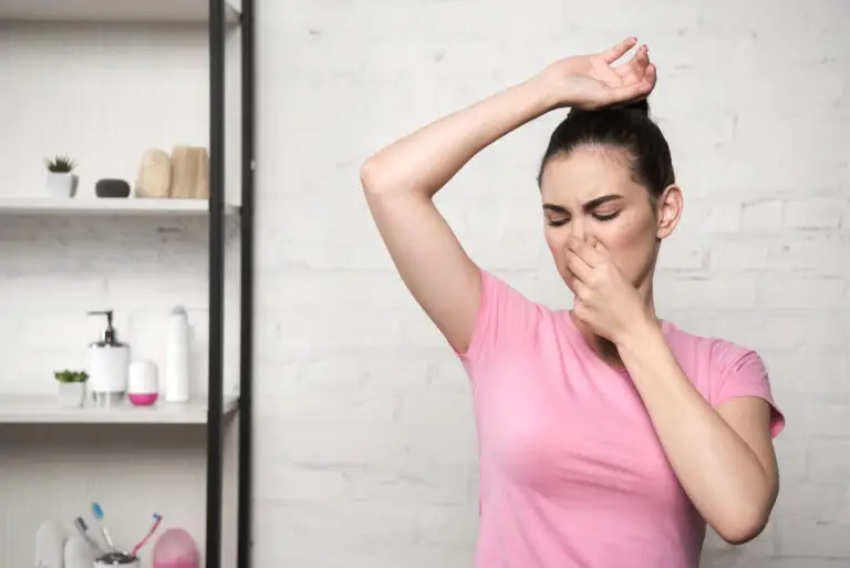woman holding nose smelling bad body odor