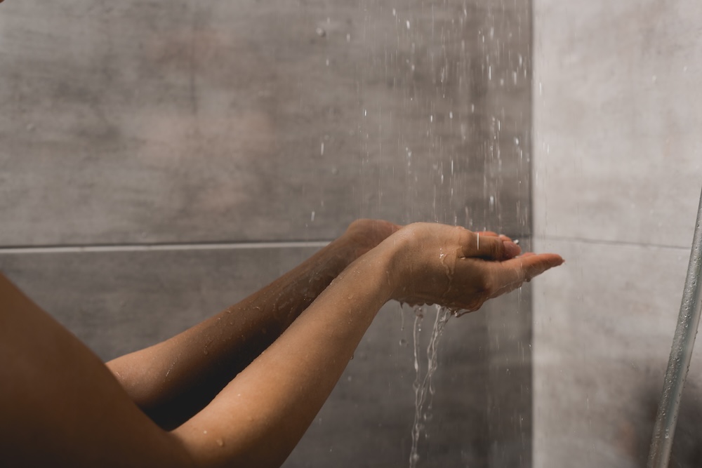 woman taking shower conserving water