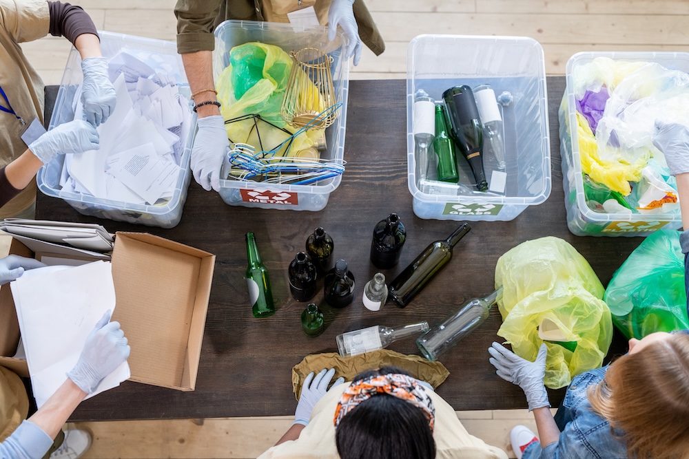 group of people sorting recycling in containers