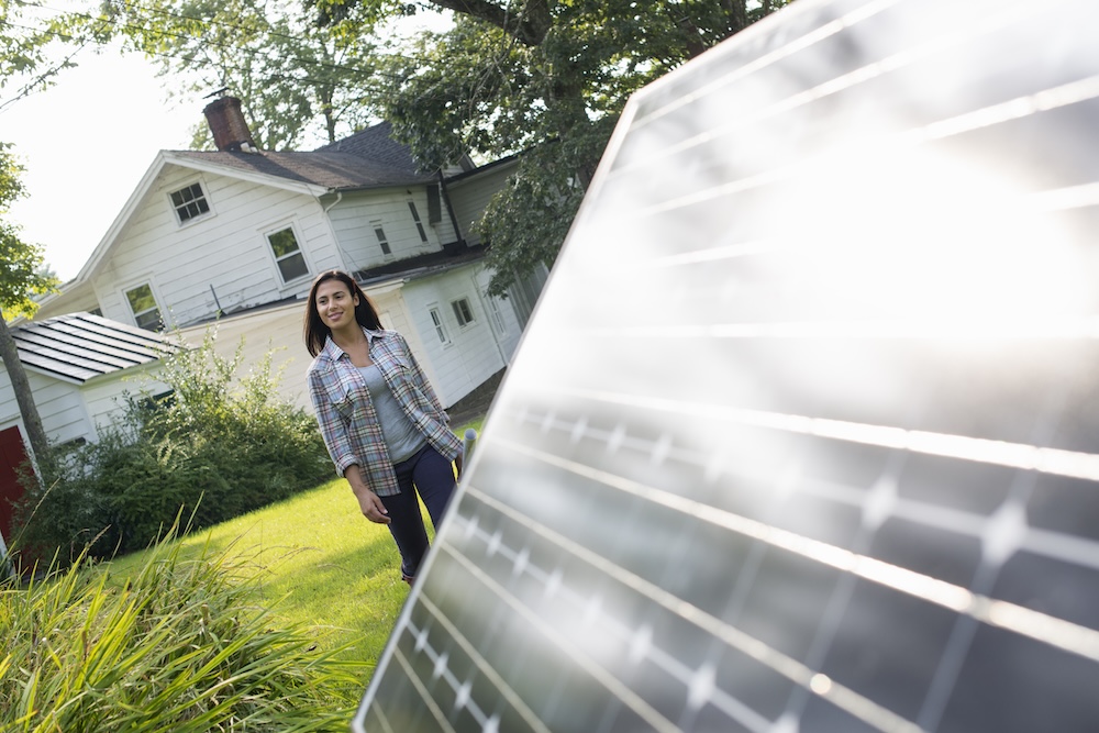 woman standing near solar panels outside