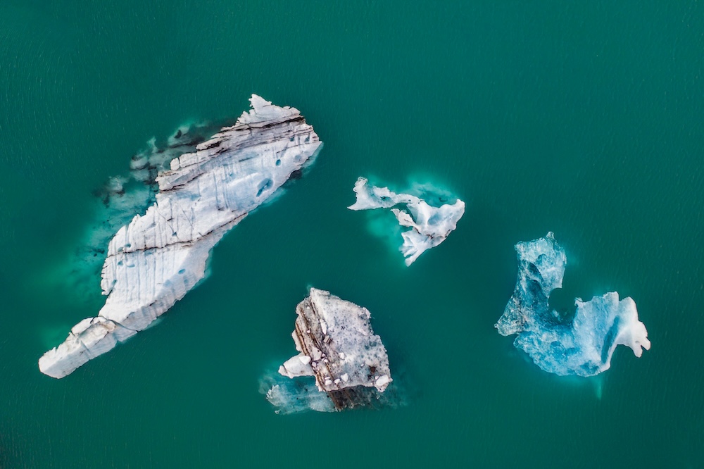 icebergs floating and melting in water