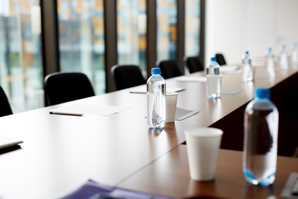 plastic bottled water and cup in a conference room