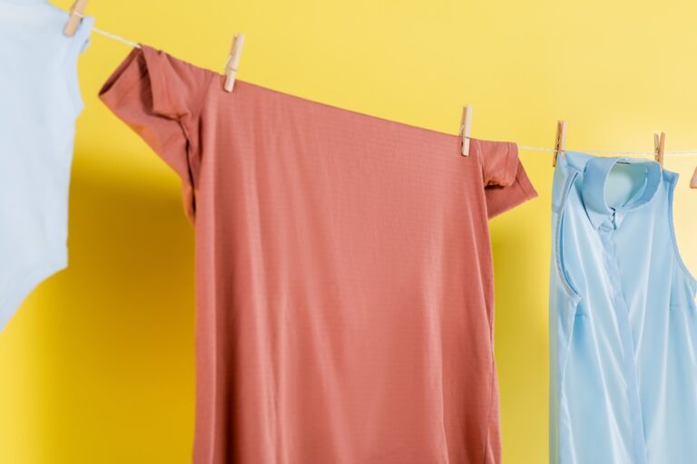 air drying clothes using close pins and a rope