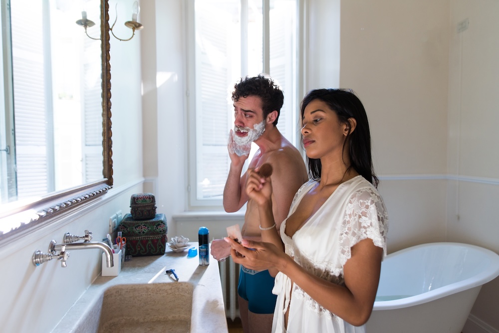 couple in the bathroom shaving and applying makeup