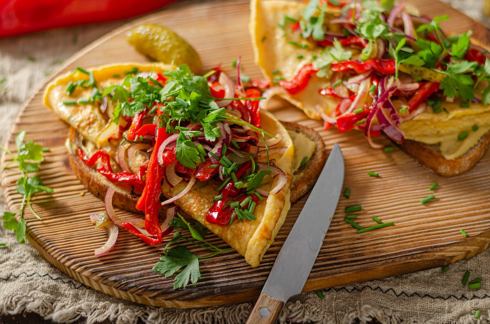 two vegetable omelettes on a cutting board