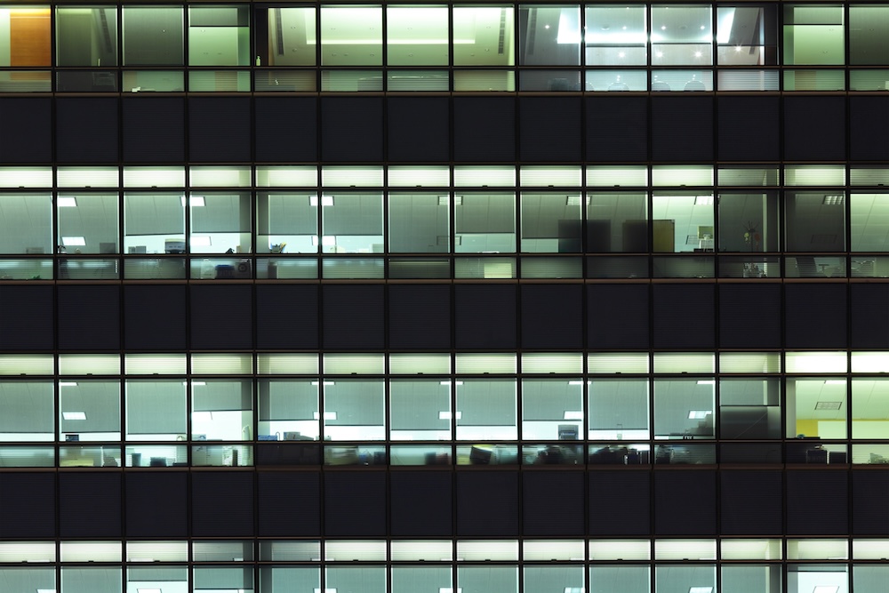 Office building with every light on each floor wasting energy