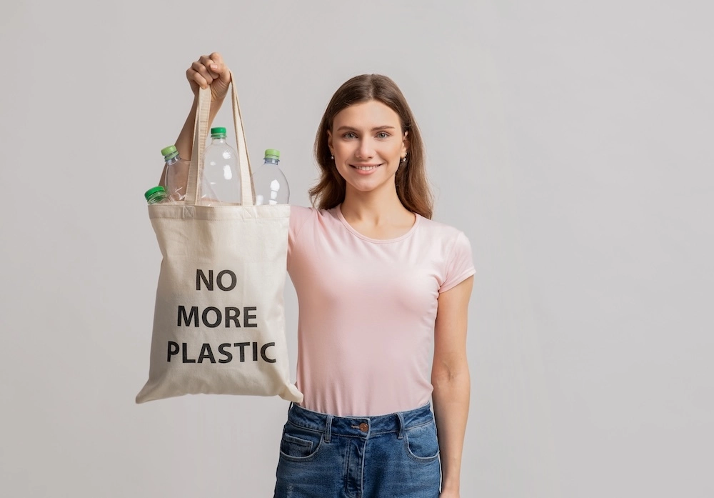 young woman with a sign that says no plastic