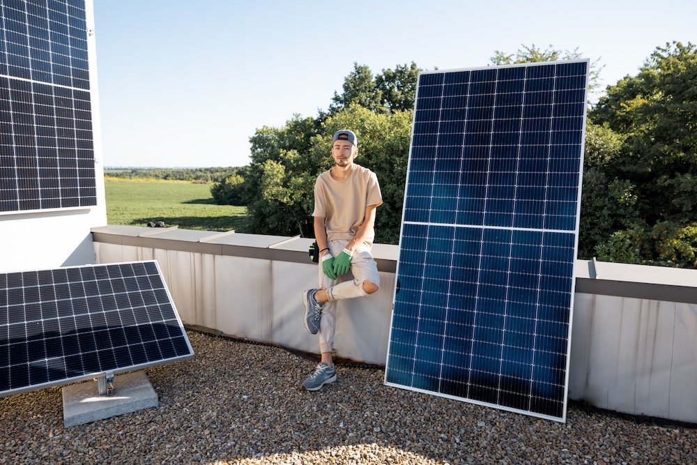 Man standing on a roof near Grid‑Tied Solar Systems