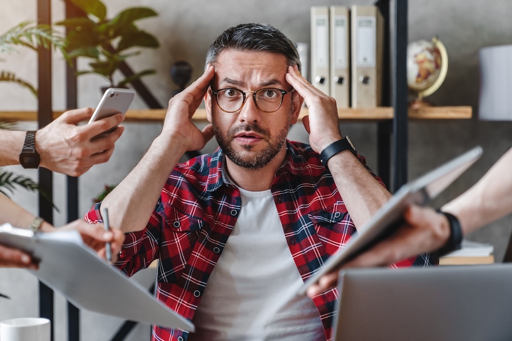 man overwhelmed by media fatigue across devices