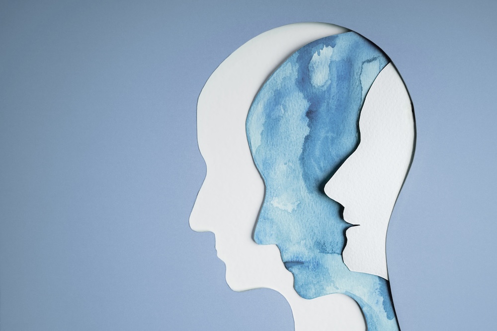 outline of multiple faces with mental health issues