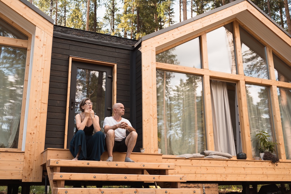 off-grid house with couple sitting on steps