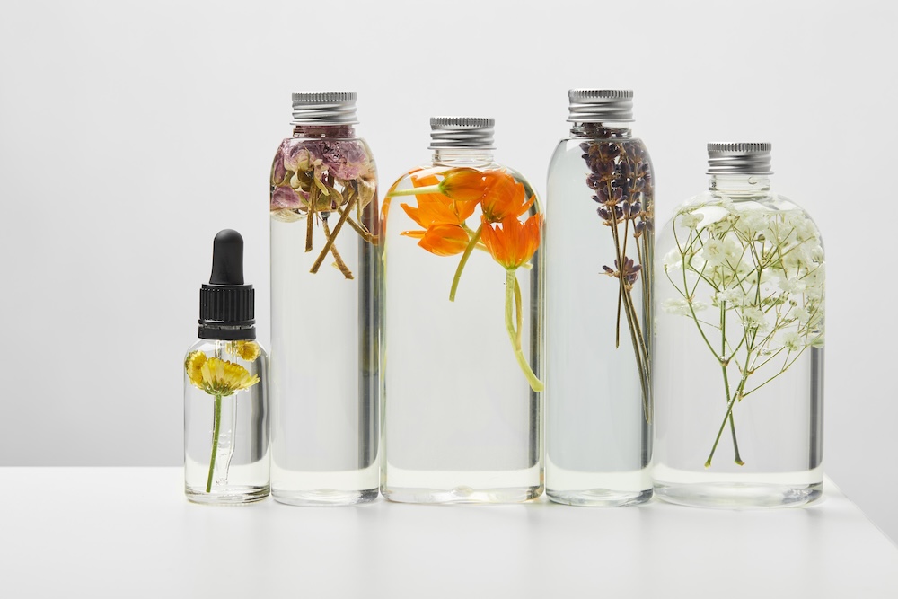 botanical flowers in bottles of oils