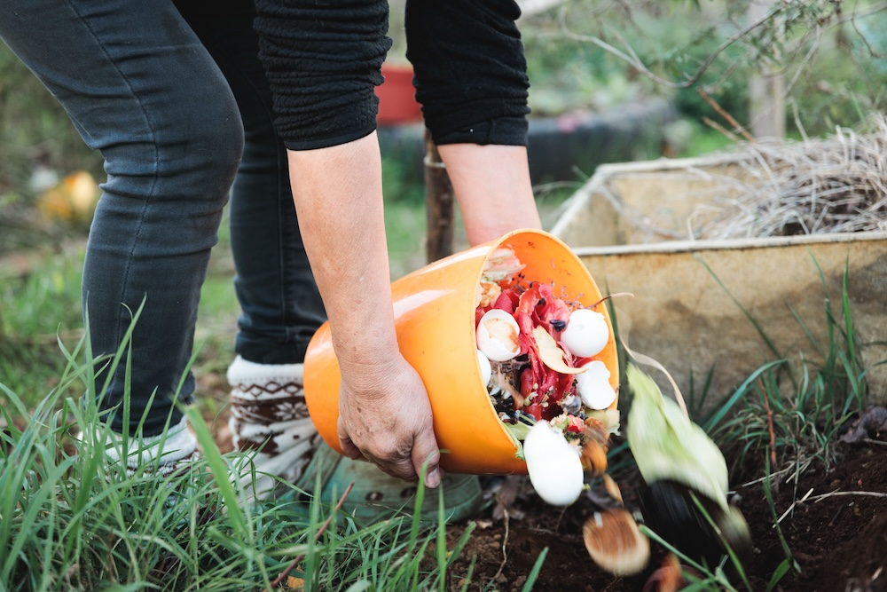person creating a composting area in yard