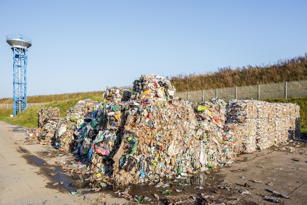 plastic bales of garbage processing in a landfill