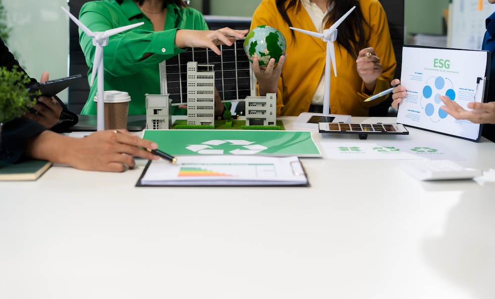 team sitting around a desk discussing sustainable alternatives