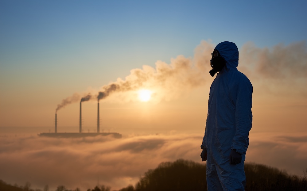 person standing with mask watching thermal pollution at a chemical plant