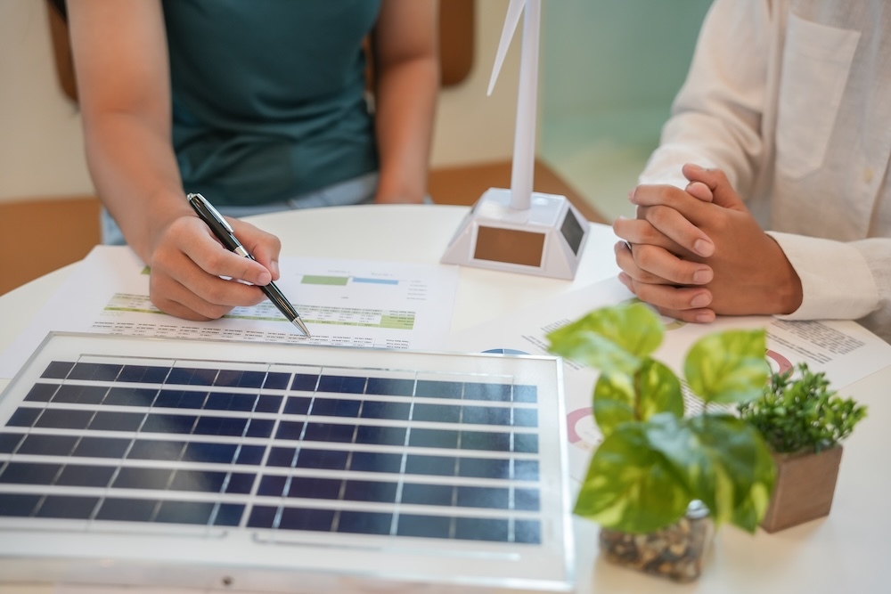 person explaining solar panels to another person