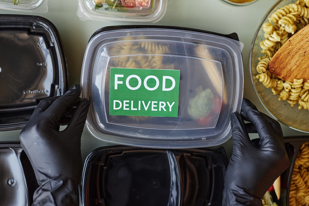black plastic container with words food delivery to an office