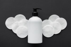 bottle of makeup remover with makeup pads