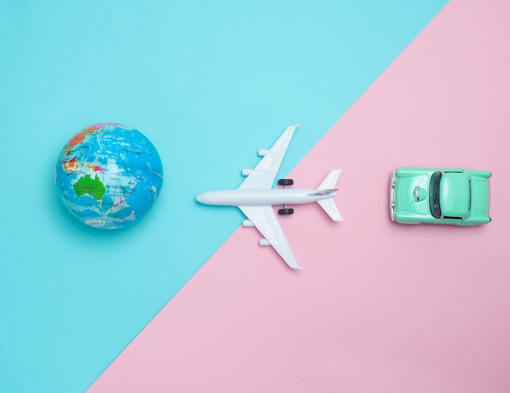 earth on left airplane in the center and car on the right