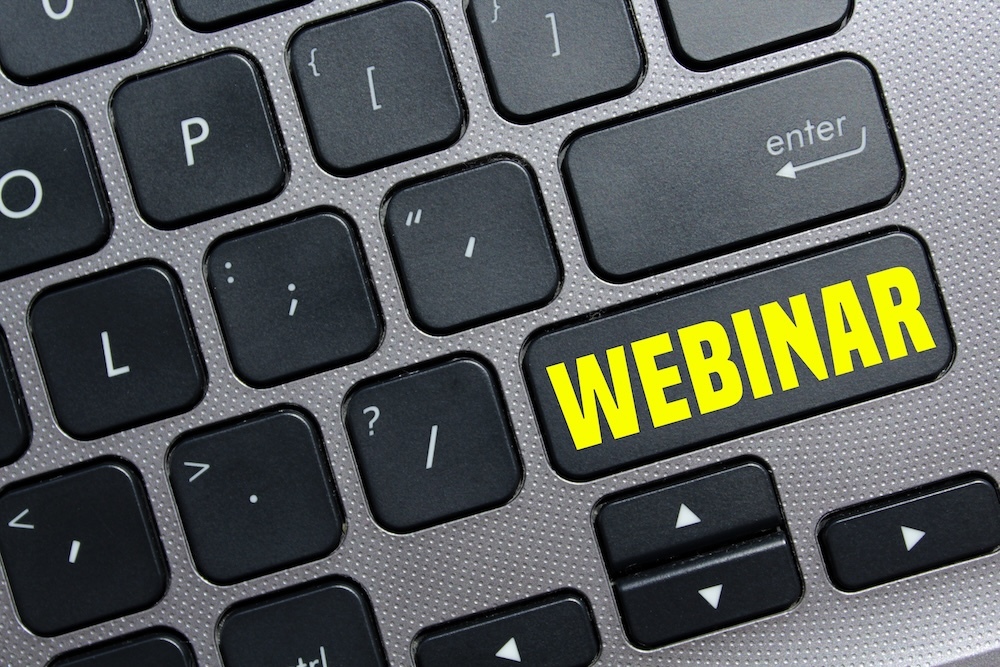 digital events on a keyboard that says webinar in yellow