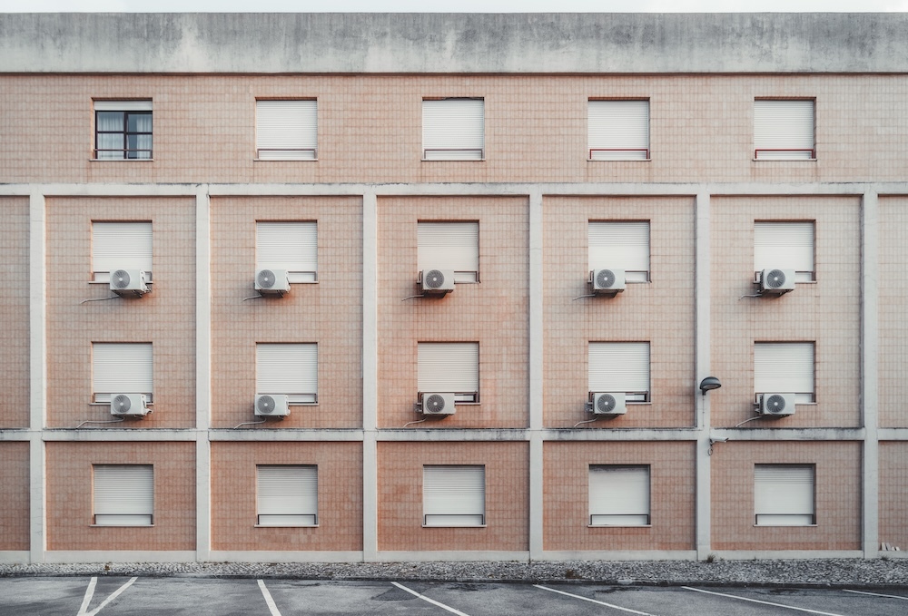 building with many hvac systems sitting outside windows